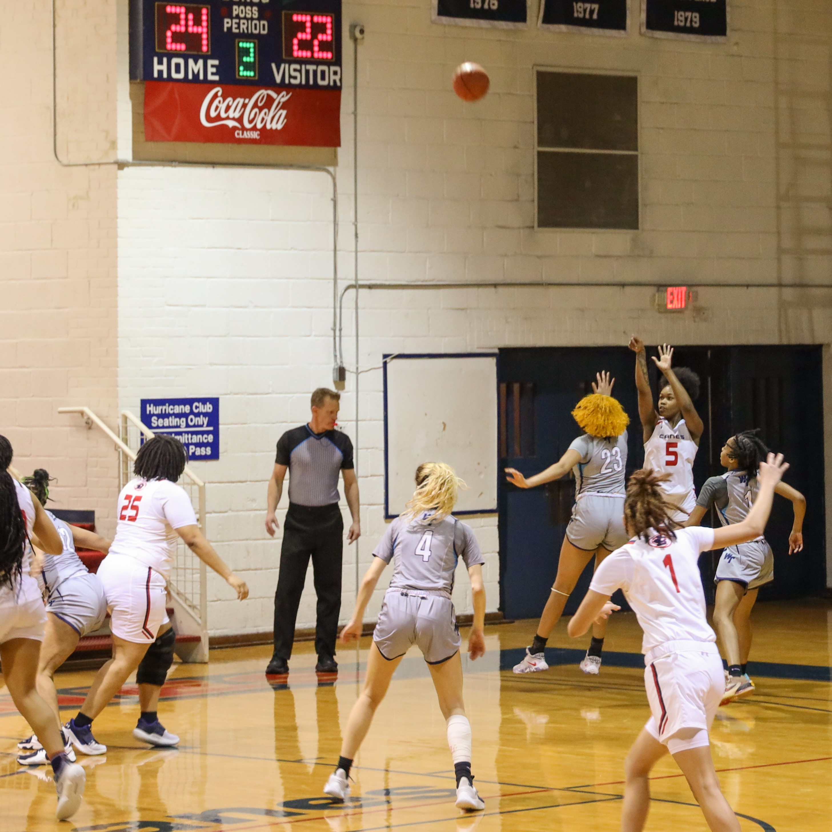 Women's basketball player makes 3-point shot.