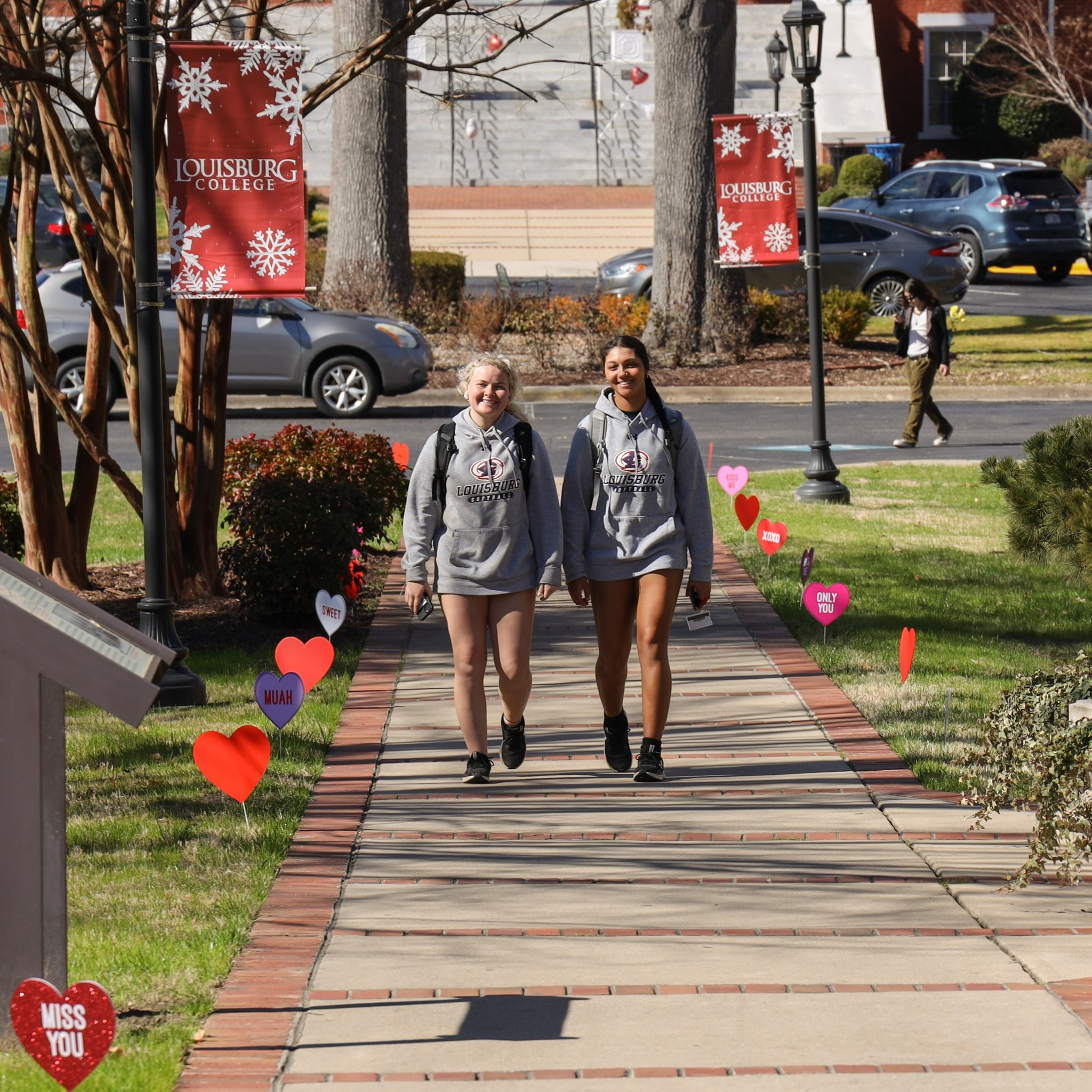 Two femaile students walking on campus.