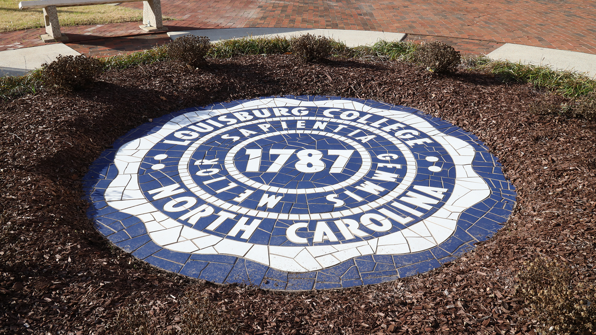 Image of the College Seal by the Main Building.