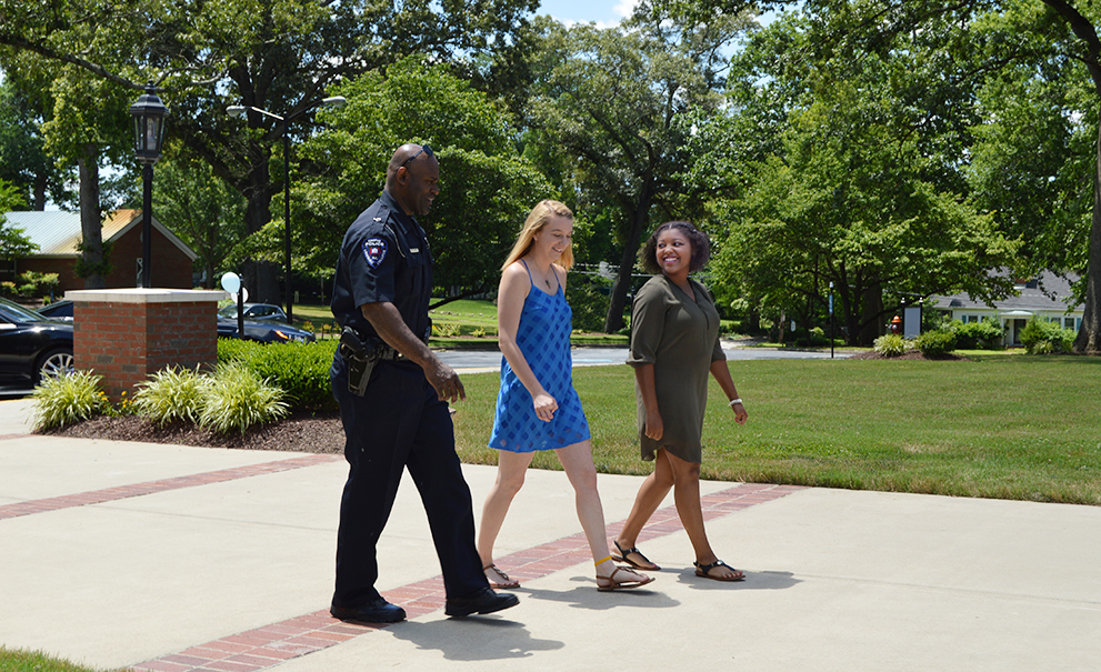 officer walking with students