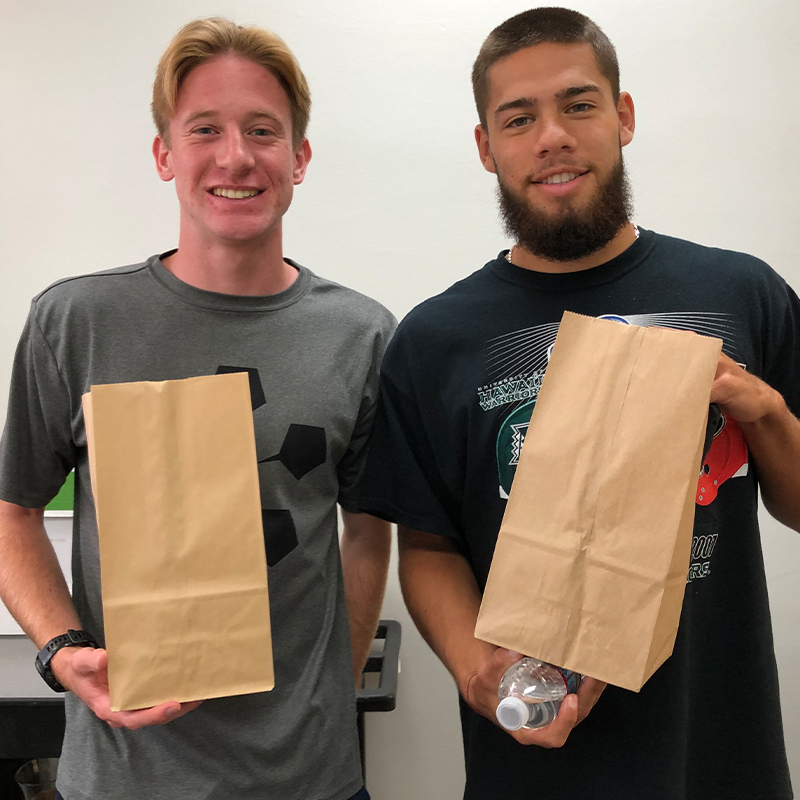 Two students smiling.