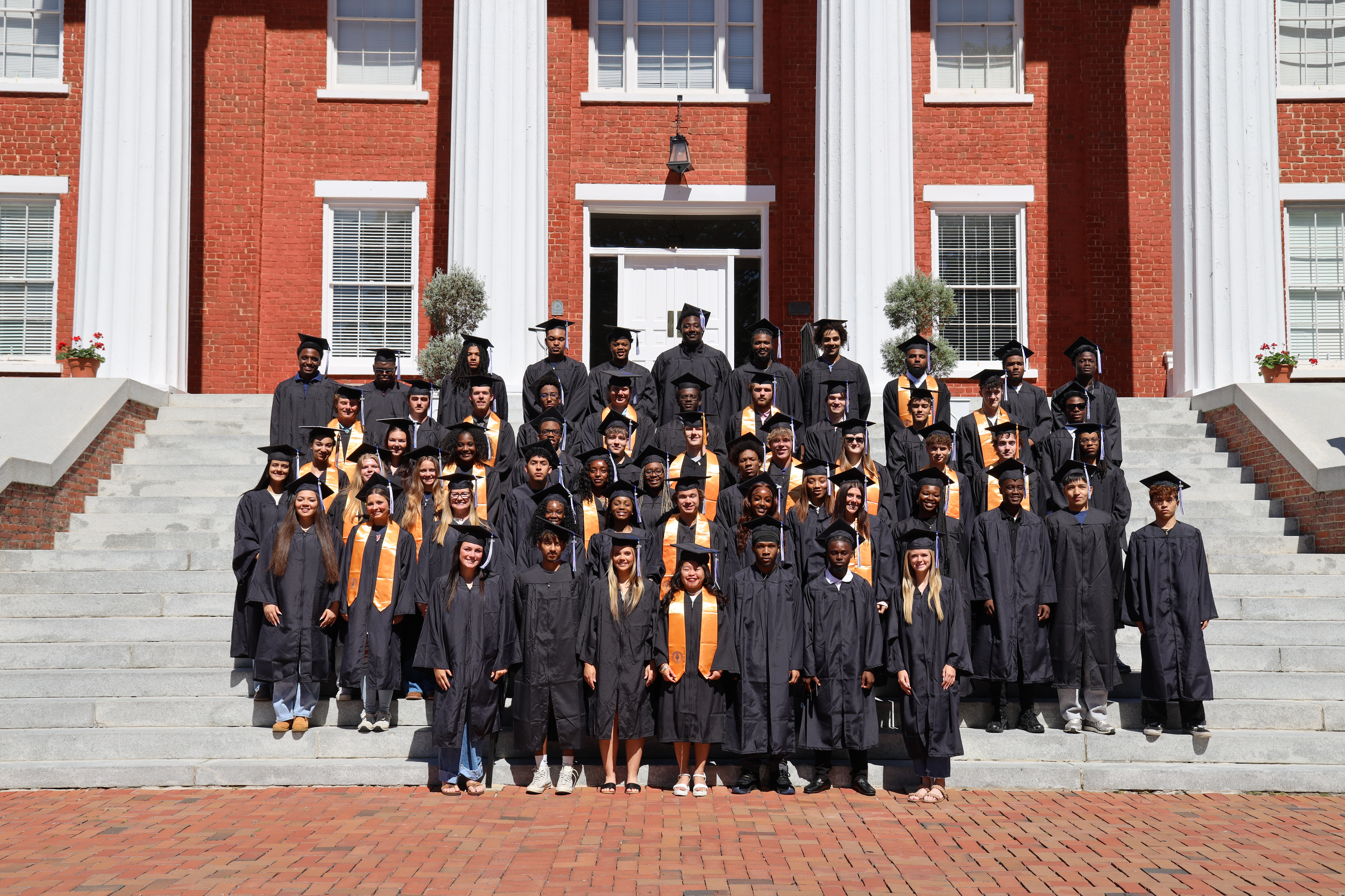 The Louisburg College 2026 Graduating class stands on the steps of Main