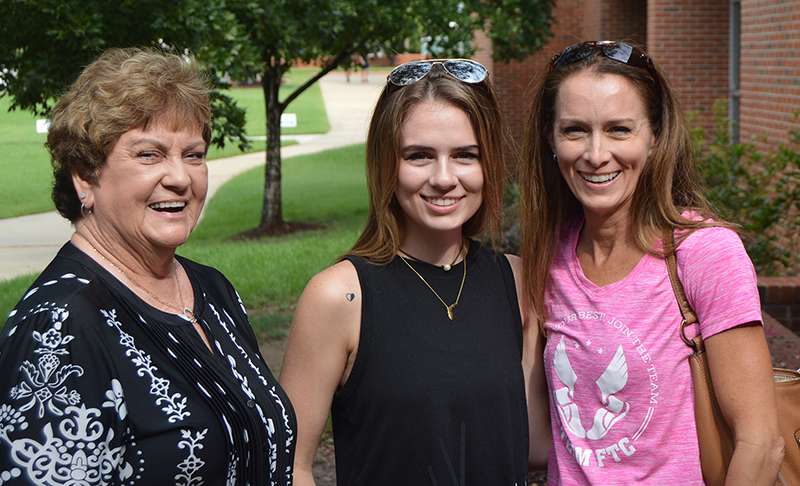 three ladies smiling