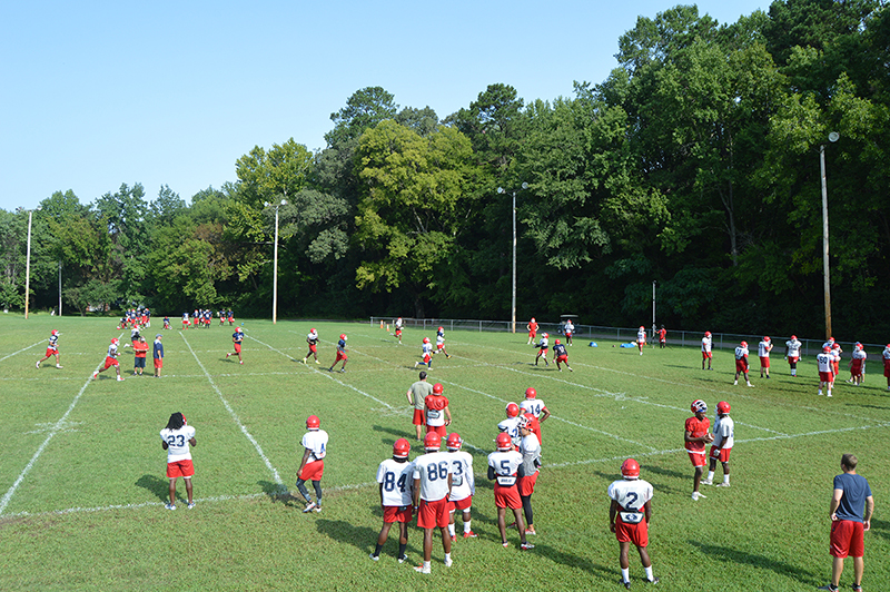 football players on a field practicing